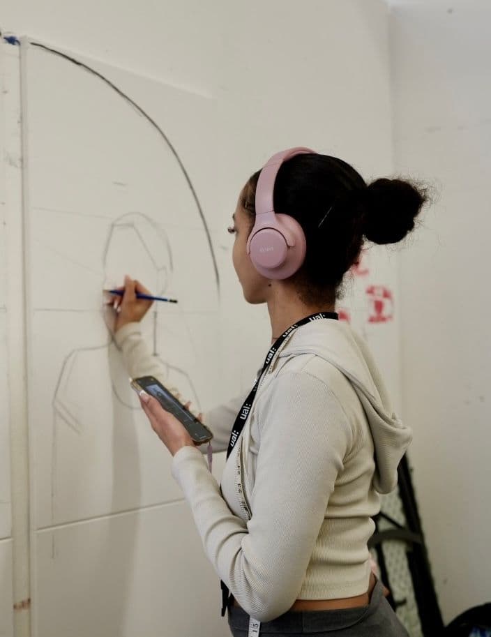 Loretta Yussuff in the studio in front of works in progress.